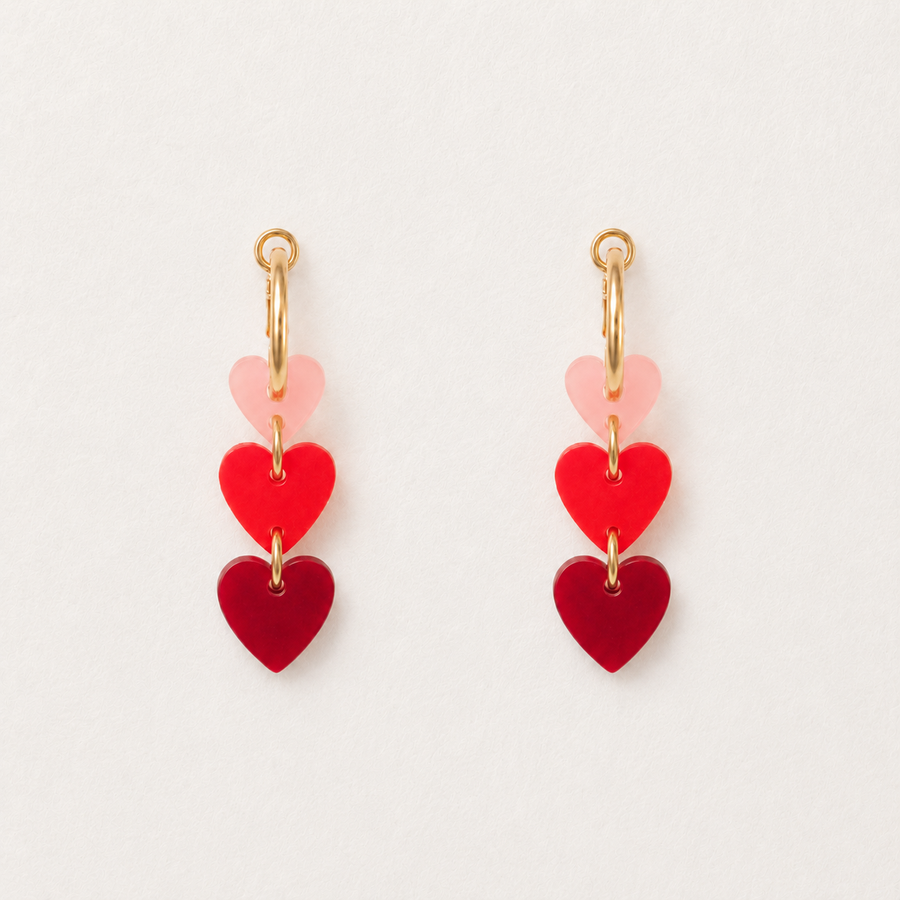 Pair of heart-shaped earrings on a light background