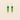 Pair of earrings with heart-shaped green and gold components on a beige background