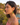 Woman wearing colorful heart-shaped earrings with a scenic background