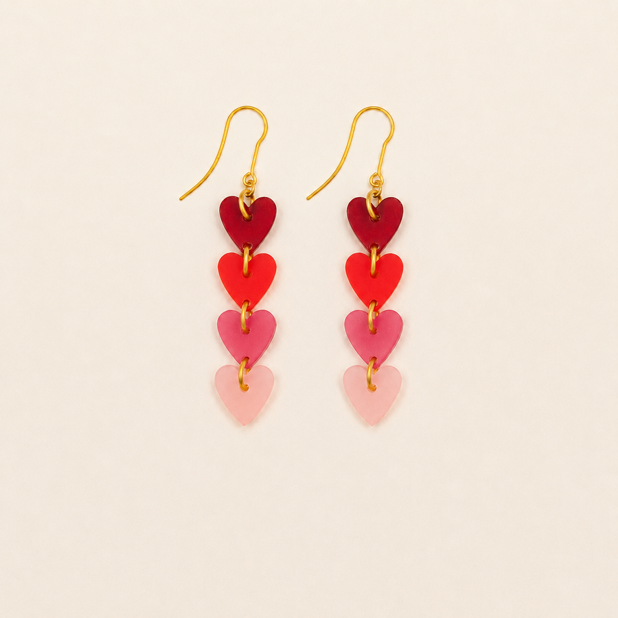 Heart-shaped earrings on a beige background