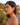 Woman wearing red heart-shaped earrings with a scenic background