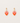 Heart-shaped earrings with pink and orange gradient on a light gray background