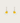 Heart-shaped earrings with yellow centers on a light gray background