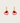 Gold hoop earrings with red heart charms on a beige background