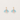 Pair of earrings with pastel-colored leaf-like charms on a light background