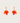 Pair of orange leaf-shaped earrings on a light gray background