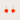 Pair of orange leaf-shaped earrings on a light gray background