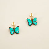 'Petite Butterfly in Teal' stud earrings featuring turquoise butterflies with a pink dot by Materia Rica.