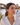 Model wearing Salvador Dalí tiger pattern acrylic hook earrings in Costa Brava setting
